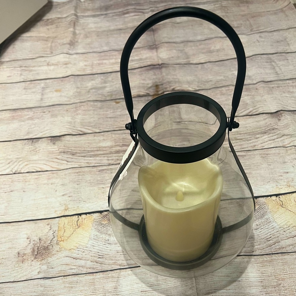Tabletop lantern with lighted candle